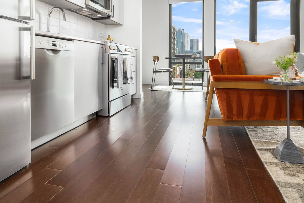 a kitchen with stainless steel appliances and a view of the city