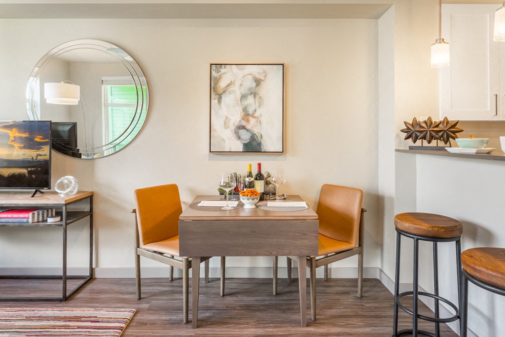 a dining room with a table and chairs and a kitchen