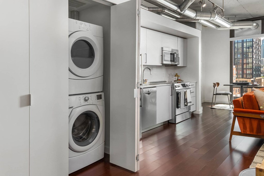 a laundry room with a washing machine and a washer and dryer in it