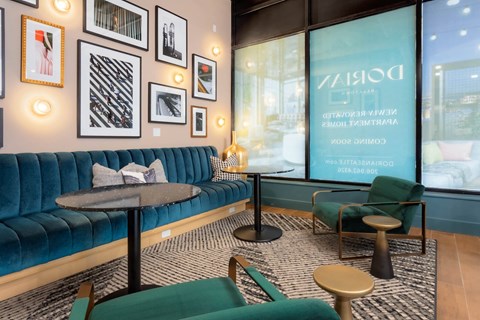 a lobby with blue couches and chairs and a large window