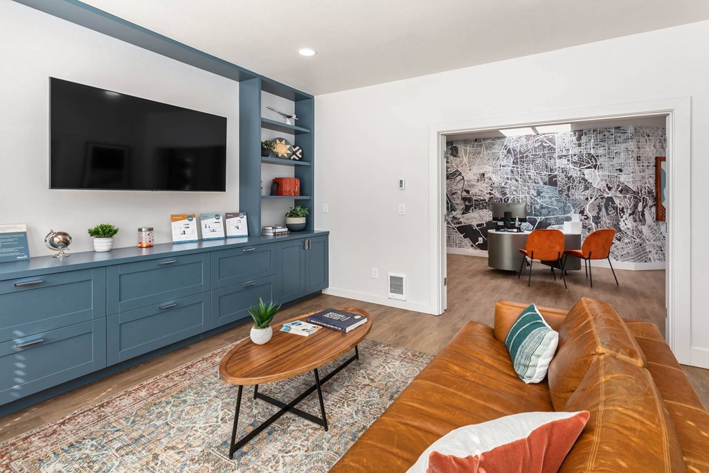 A living room with a brown couch and a wooden coffee table.