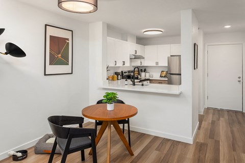 a kitchen and dining area with a small table and chairs