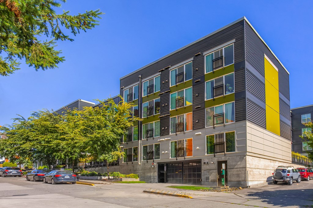 a building with a yellow and green facade on a city street
