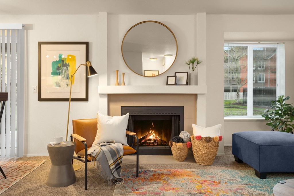 a living room with a fireplace and a mirror above it