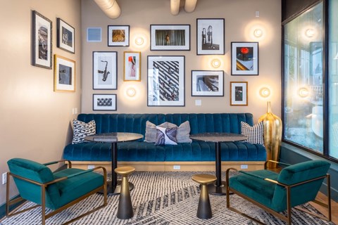 a living room with a blue couch and pictures on the wall
