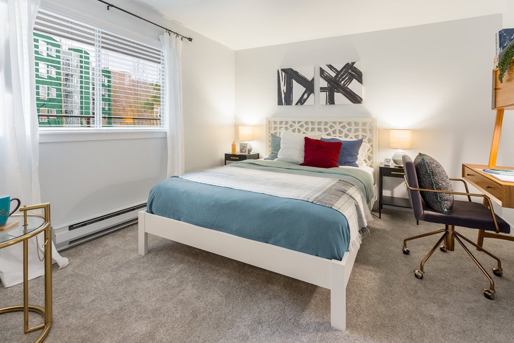 a nicely made bed in a bedroom at The Eden Apartments.