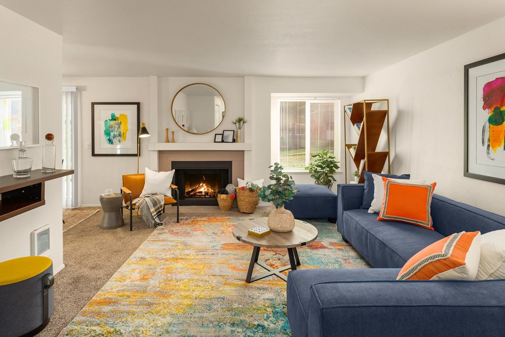 a living room with blue couches and a fireplace