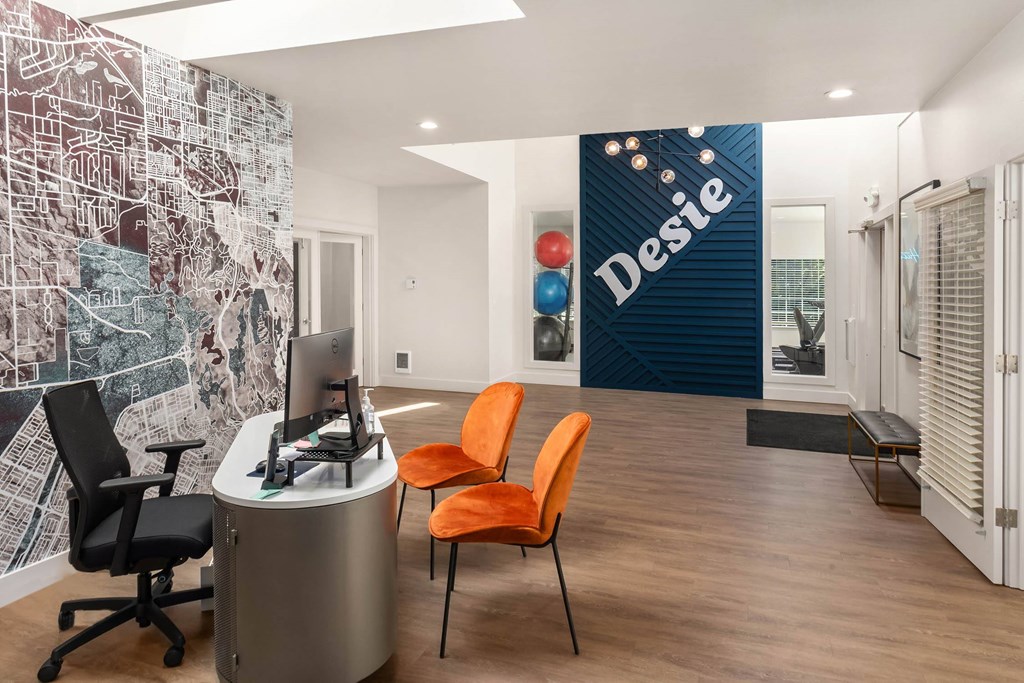 A modern office with a desk, chair, and a map on the wall.