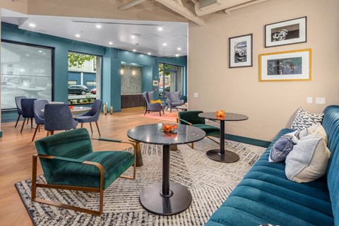 a living room with a blue couch and chairs and tables