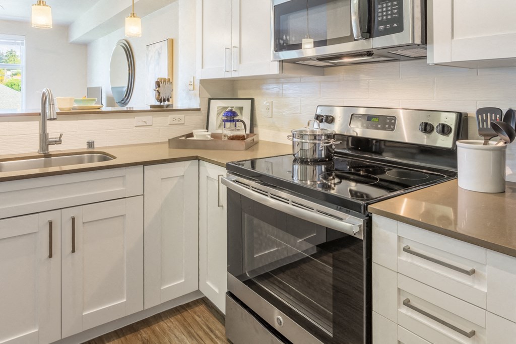 a kitchen with stainless steel appliances and white cabinets