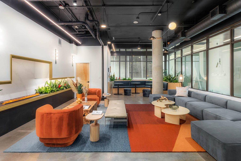 a living room with couches and tables and a ping pong table
