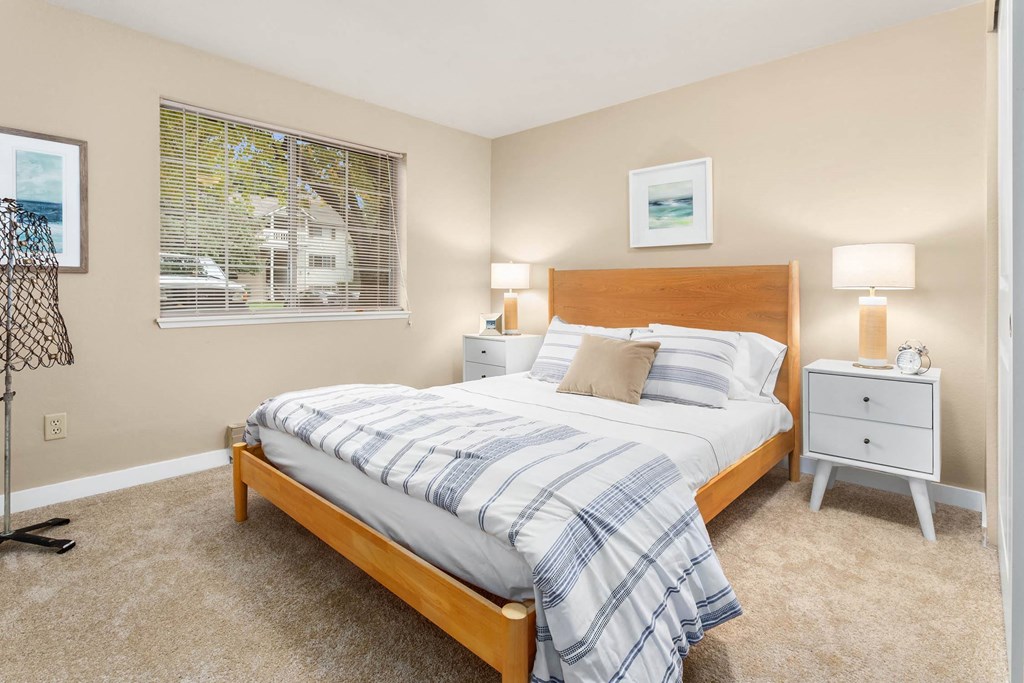 a bedroom with a bed and a window