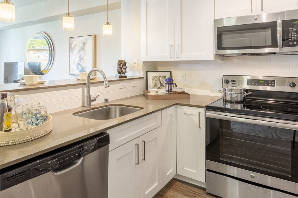 a kitchen with stainless steel appliances and white cabinets