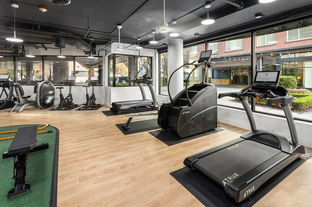 a gym with treadmills and other exercise equipment