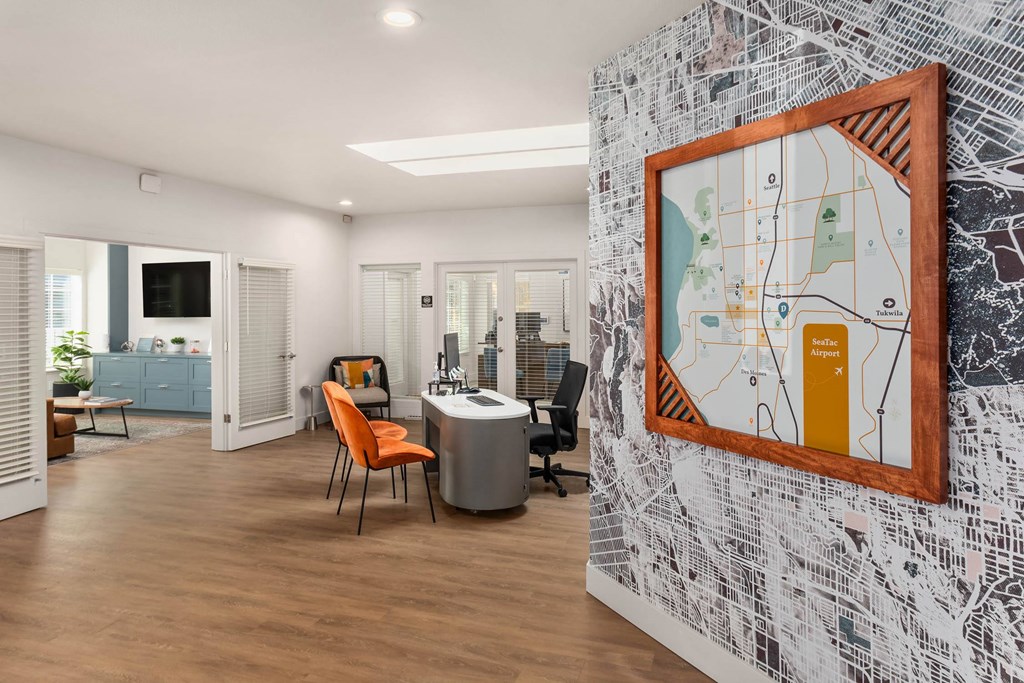 A room with a map on the wall and a chair in front of it.