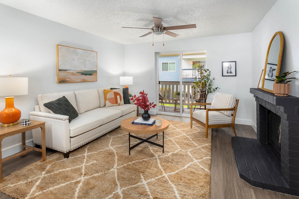a living room with a white couch and a fireplace