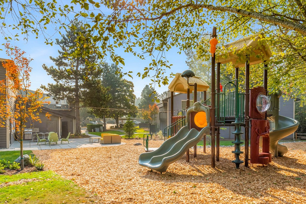 a playground with a swing set and slides