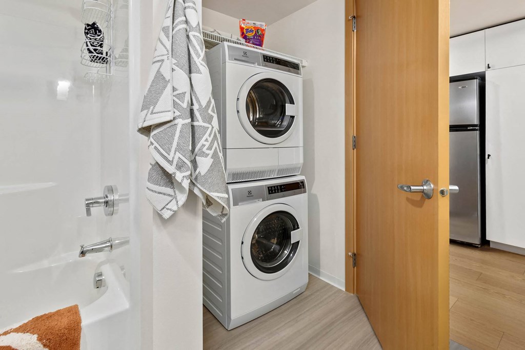a small bathroom with a washing machine and a dryer