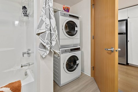 a small bathroom with a washing machine and a dryer