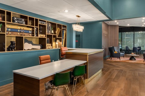 a room with a long white table and chairs and a blue wall