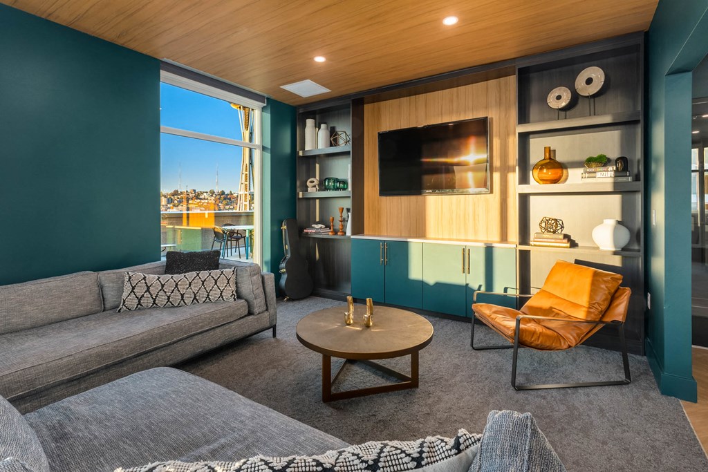 a living room with couches and a coffee table and a television