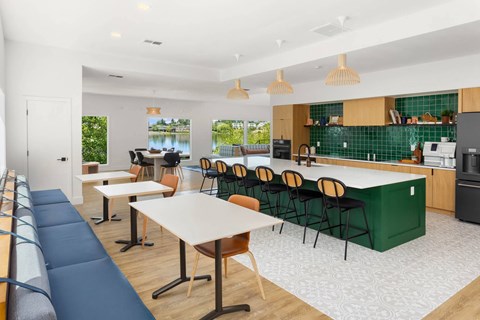 a communal kitchen and dining area with tables and chairs