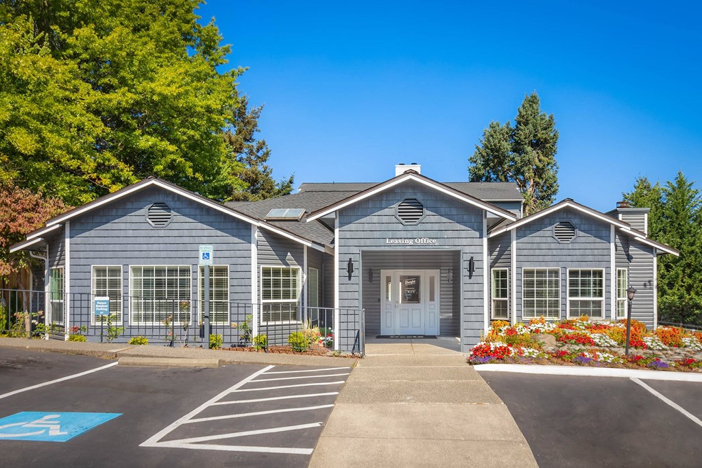 A building with a parking lot in front of it.