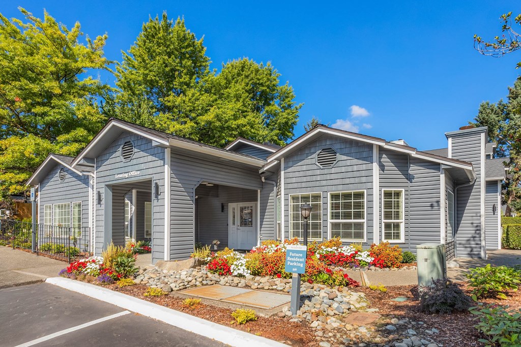 A blue house with a sign in front of it.