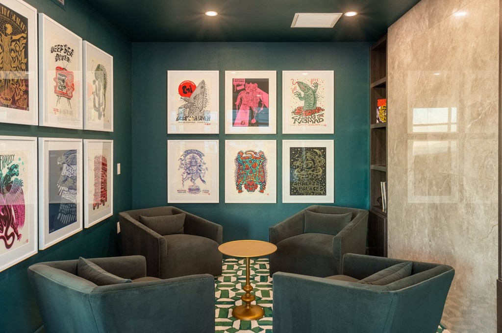 a lobby with couches and posters on the wall