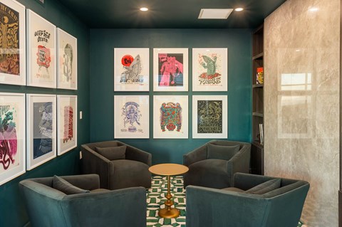 a lobby with couches and posters on the wall