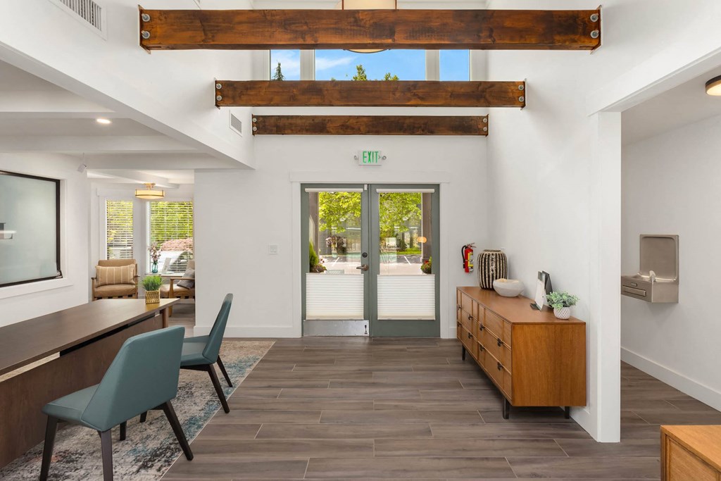 a view of the entryway of a house with wood floors and white walls