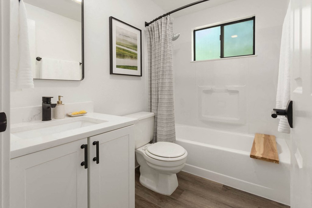 a bathroom with a toilet sink and bathtub