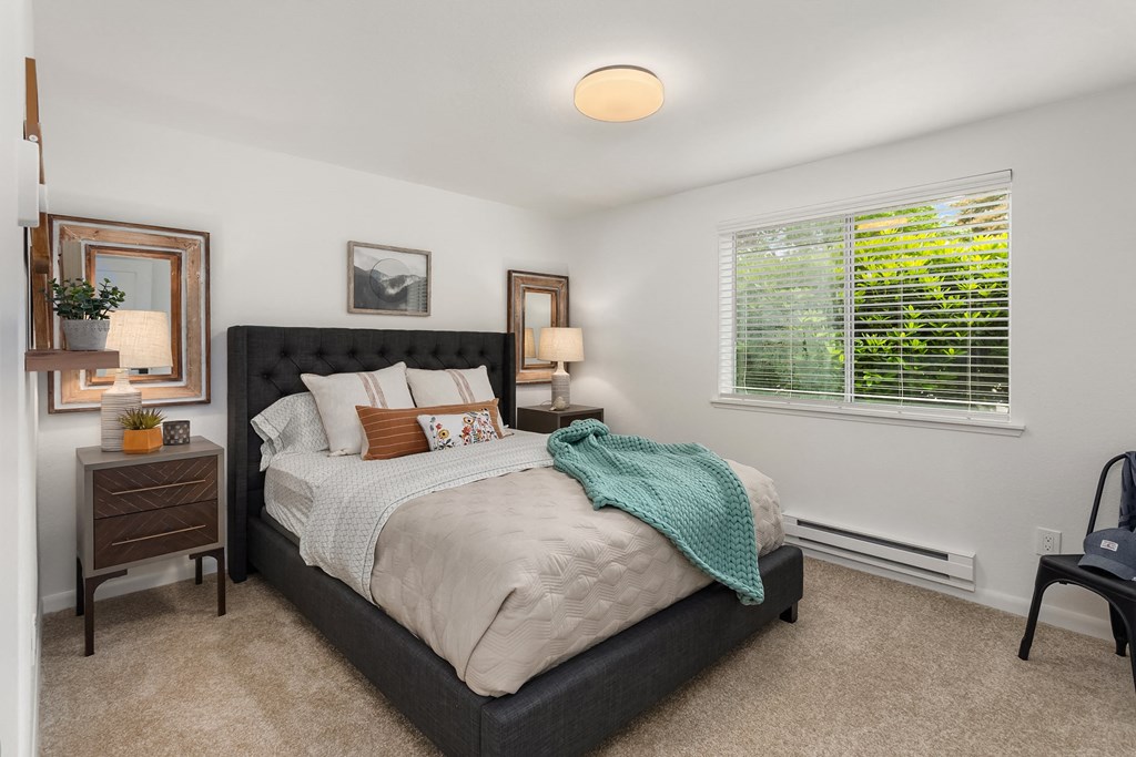 a bedroom with a bed and a window