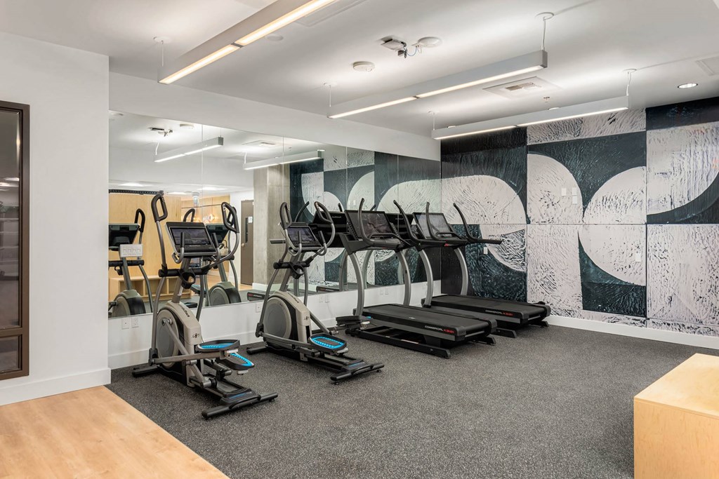 a gym with treadmills and other exercise equipment