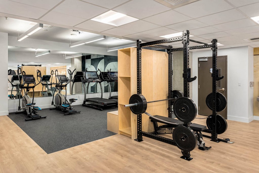 a gym with weights and other exercise equipment in a workspace