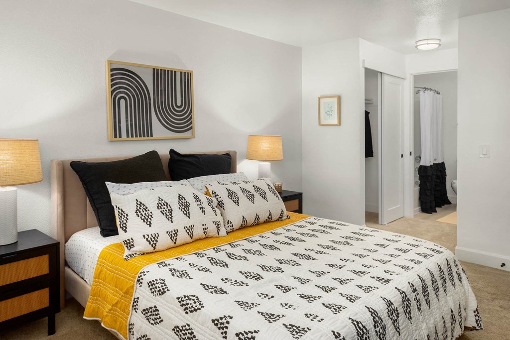 a bedroom with a bed and two night stands