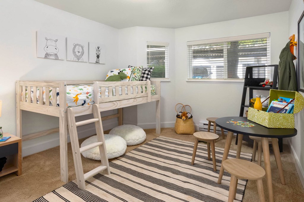 a bedroom with a bunk bed and a desk with a chair