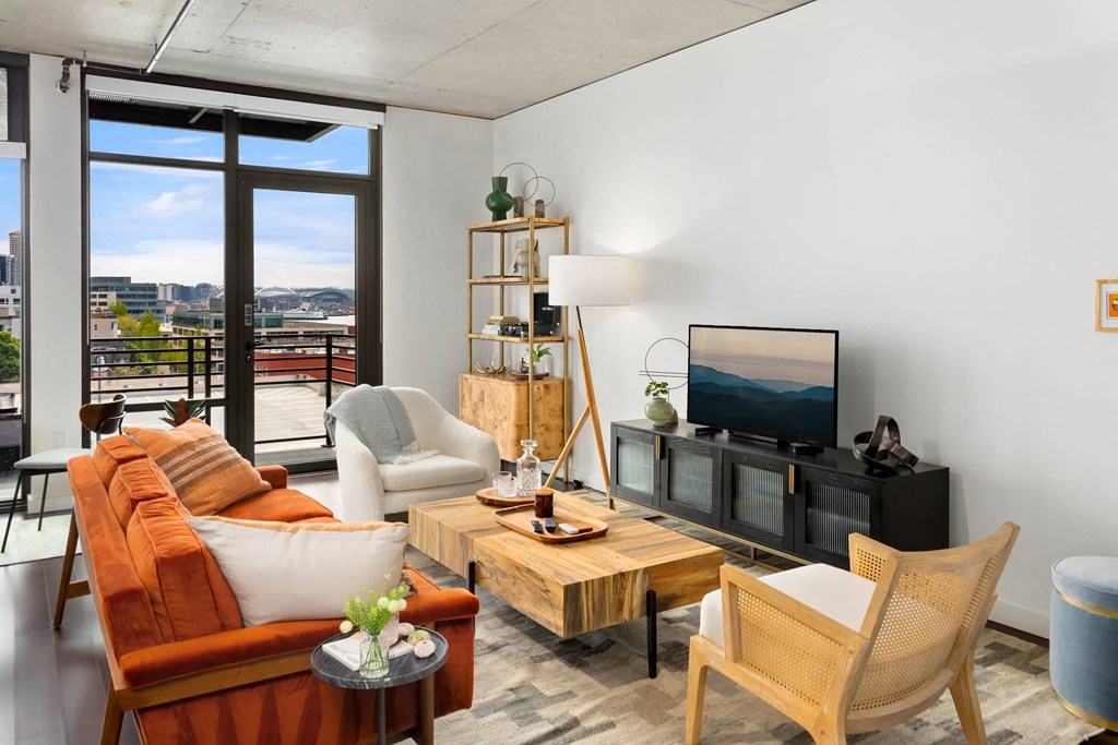 a living room with an orange couch and a television