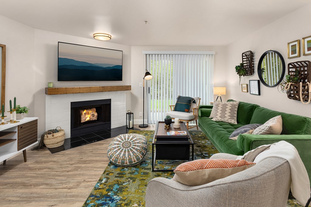 a living room with a fireplace and a green couch