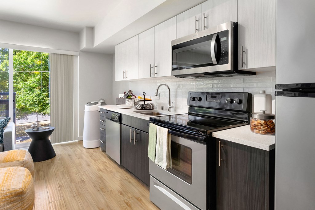 a kitchen with stainless steel appliances and a microwave