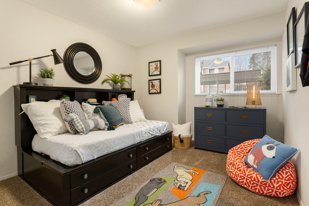 a bedroom with a bed and a dresser and a window