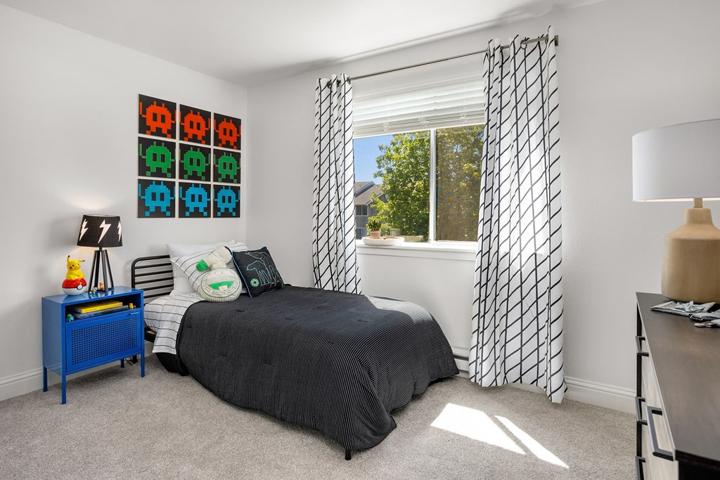 a bedroom with a bed and a window