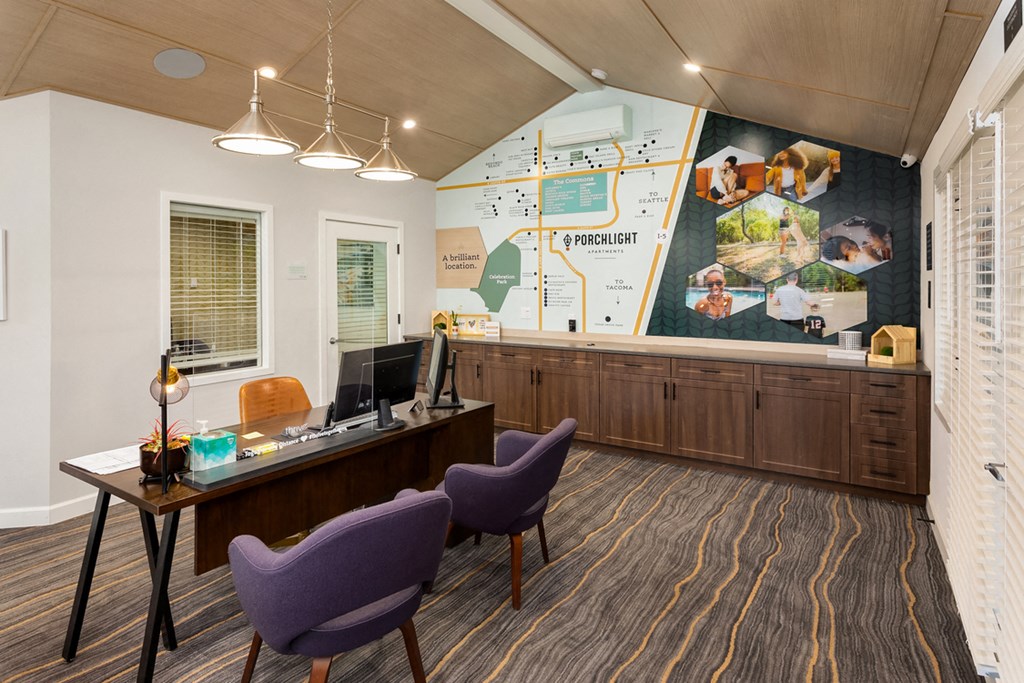 a conference room with a desk and chairs and a wall mural