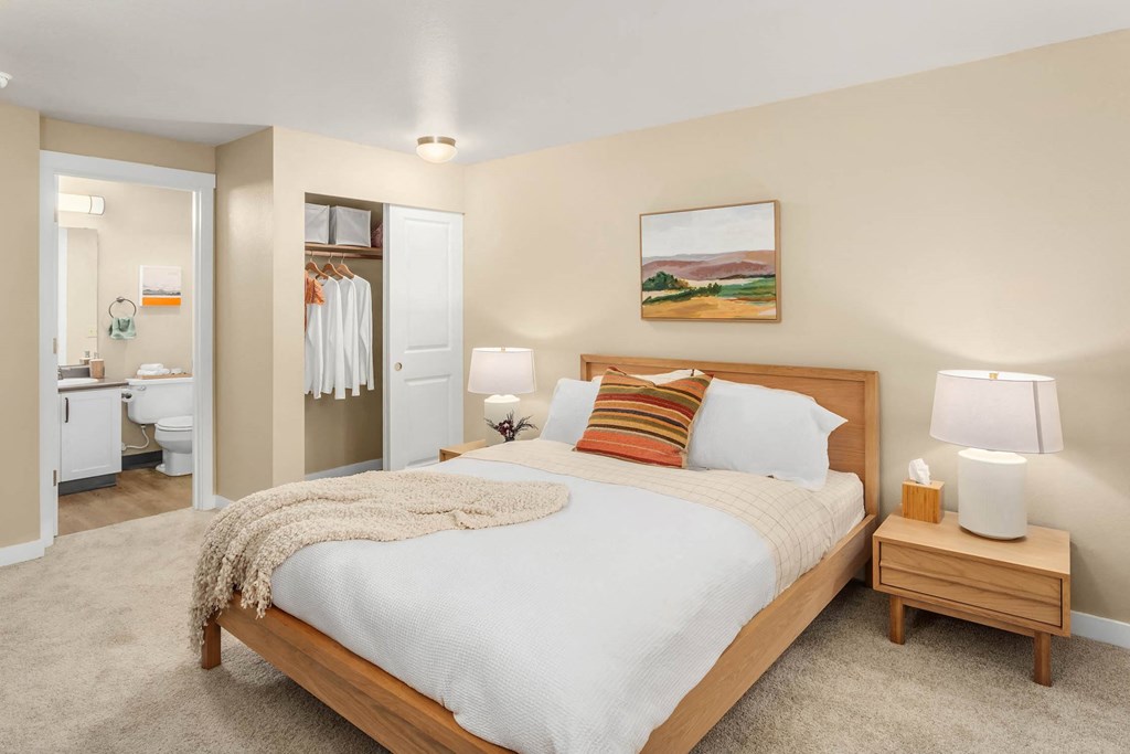 a bedroom with a bed and a bathroom with a toilet