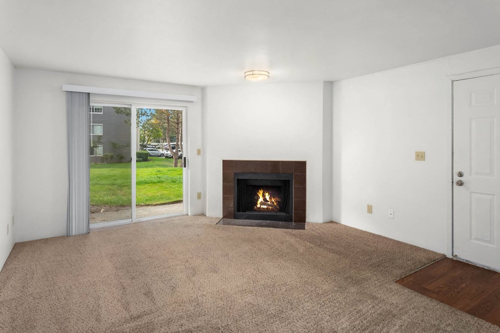 a living room with a fireplace and a sliding glass door