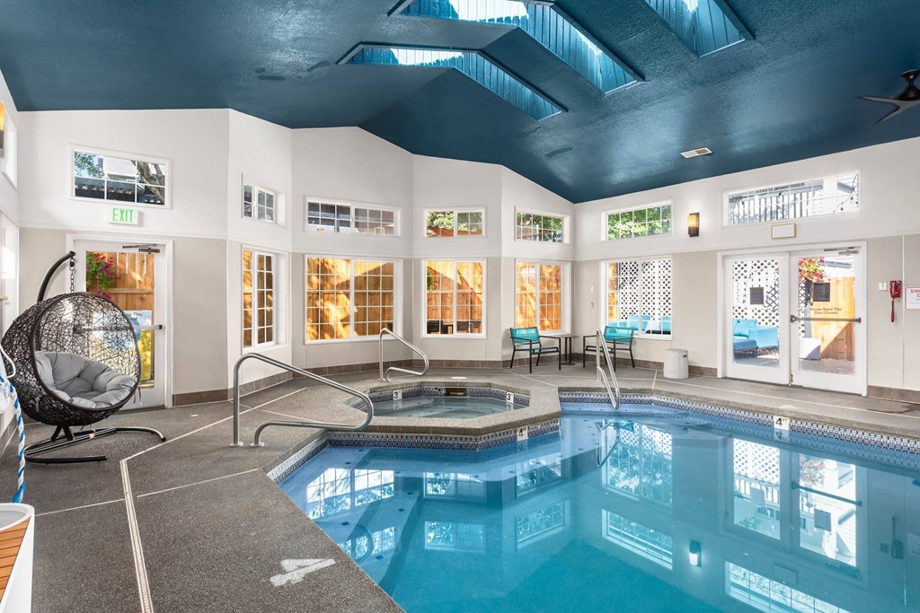 A large indoor swimming pool with a sunken seating area.
