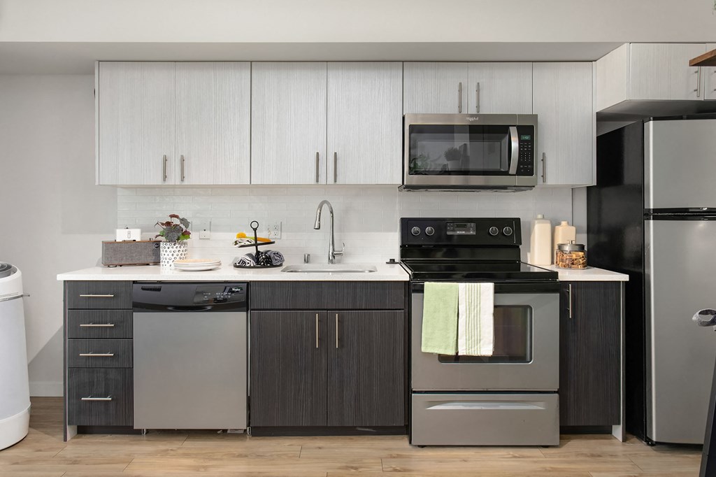 a kitchen with stainless steel appliances and white cabinets