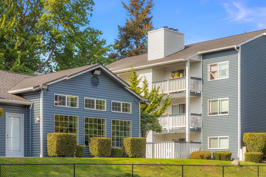 a house with a blue exterior and a white fence
