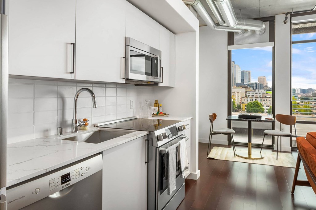 a kitchen with a sink and a stove and a window
