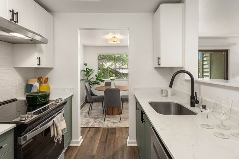 a kitchen and dining room with a sink and a window